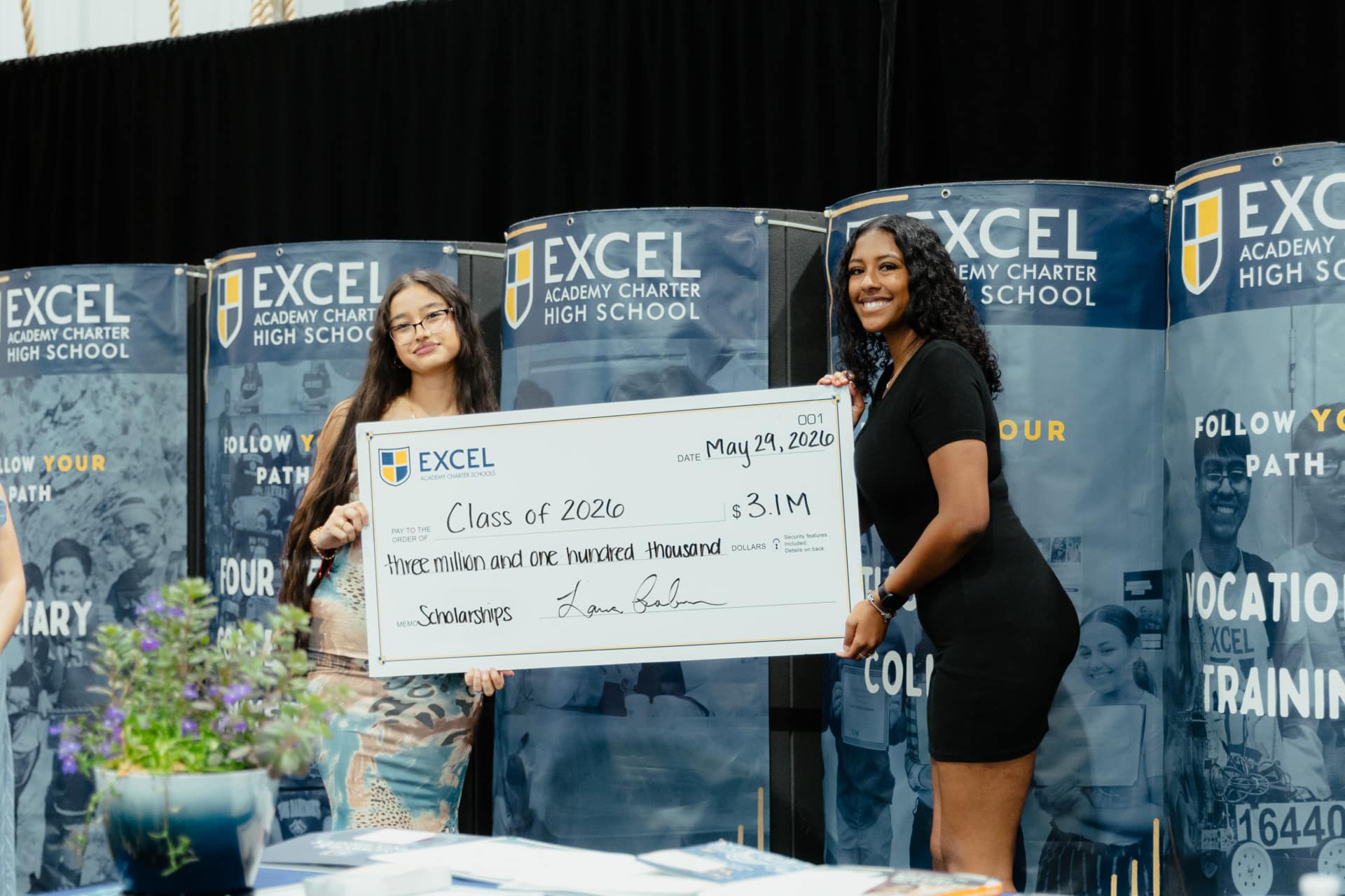 595A3539 two students hold a large check